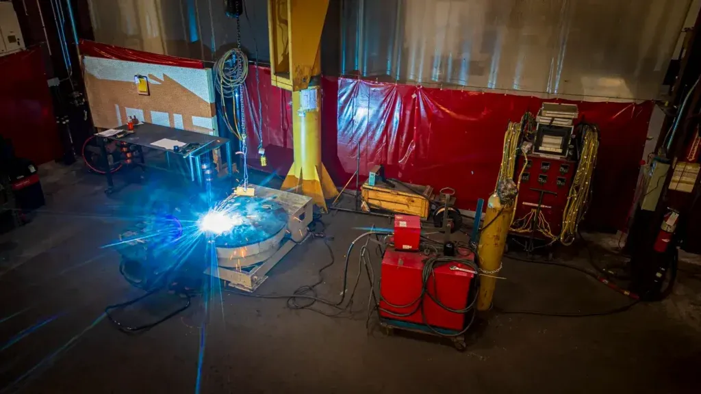 High view of worker repairing cylinder